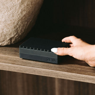 ZEYA Portable Diffuser with a fragrance card being inserted into the front slot