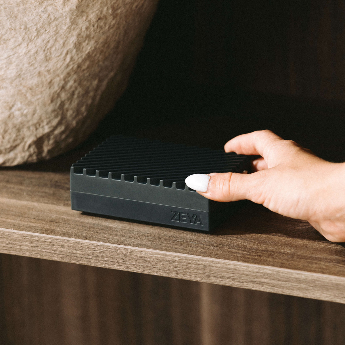 ZEYA Portable Diffuser with a fragrance card being inserted into the front slot