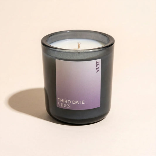 ZEYA Third Date Vibes candle styled with its scent notes of saffron, honeyed rose, cedarwood and musk