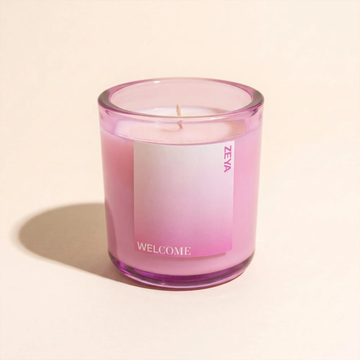ZEYA Welcome candle styled with its scent notes of blackberry, grapefruit and vetiver